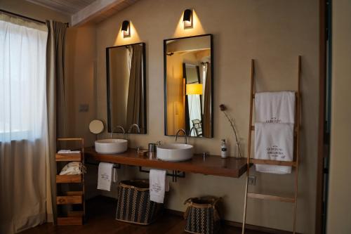 a bathroom with two sinks and two mirrors at Quinta da Abelheira 1660 in Sobral da Abelheira