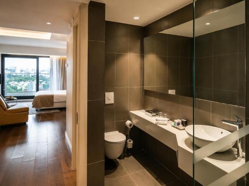 a bathroom with a sink and a toilet in a room at חדר נוף לים הרצליה in Herzliya B