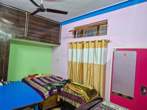 a bedroom with a bed and a ceiling fan at Dev Palace in Uttarkāshi