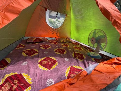 an inside of a tent with a fan in it at Sea front tent house in Murud
