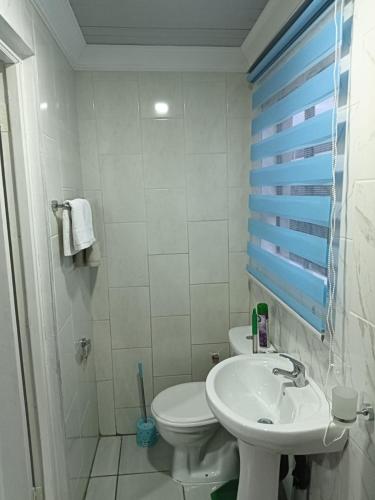 a white bathroom with a toilet and a sink at Mypeace Comfort in Pretoria