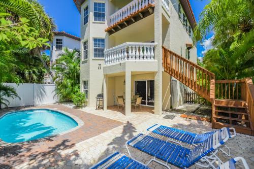 a villa with a swimming pool and a house at Villa Florence in Holmes Beach