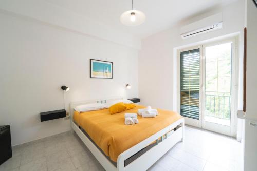 a bedroom with a bed with two towels on it at Palia's Hotel in Laino Borgo