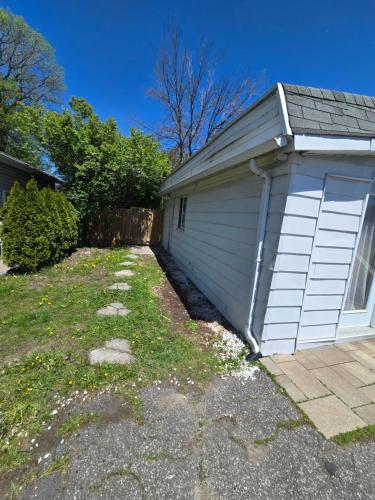 a garage with a door on the side of a house at Brossard room 3 in Brossard