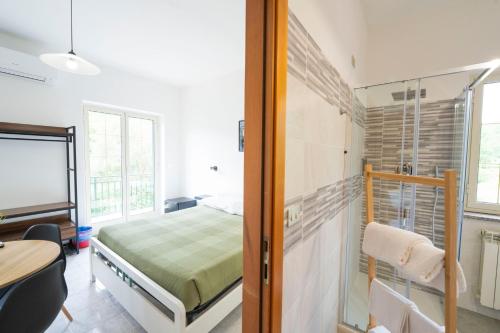 a bedroom with a bed and a desk and a table at Palia's Hotel in Laino Borgo