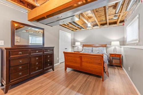 a bedroom with a bed and a dresser and a mirror at Executive 5 bdrm 3 ba House in Bonnyville