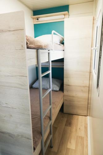 a small bedroom with bunk beds in a tiny house at Mobile Home ADRIA in Privlaka