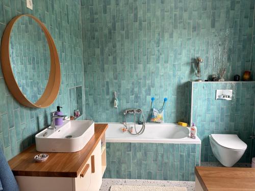 a bathroom with a sink and a tub and a mirror at Balaton Breeze in Balatonalmádi