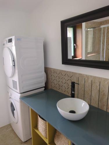 a bathroom with a sink and a microwave on a counter at PASENIÑO - Aloxamento rural in Palas de Rei