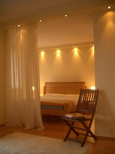 ミエンジズドロイェにあるFala Patio with Balconyのベッドルーム(ベッド1台、椅子、照明付)