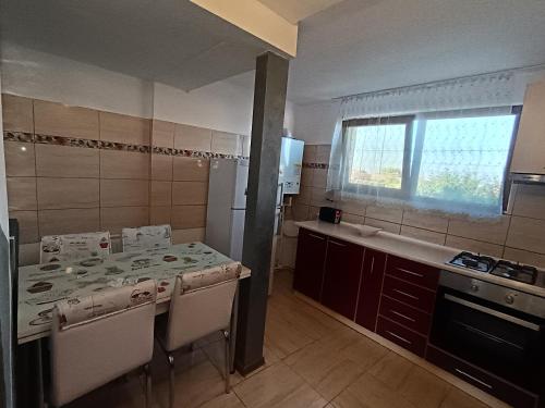 a kitchen with a table and a window in it at Proprietate privata in Lazu