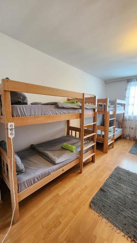 a room with three bunk beds in a room at Bunkhouse & Apartments in Prishtinë