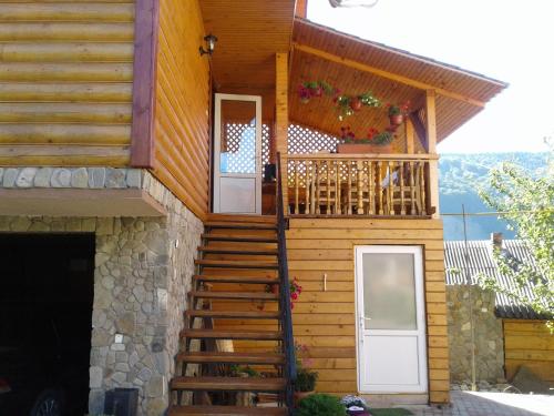 a house with a staircase and a balcony at Sadyba Hatynka in Yaremche