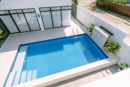 a swimming pool on the side of a house at Amethyst Bcd in Bacolod