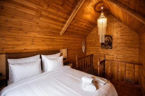 a bedroom with a bed in a wooden room at City Bungalow Hotel in Edirne