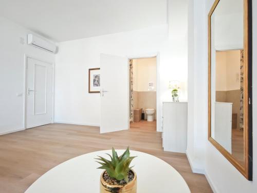 a living room with a mirror and a potted plant at Dimora Leccese in Lecce