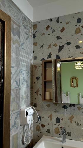a bathroom with a sink and a mirror at HOTEL VILA TOSKA in Piskupat