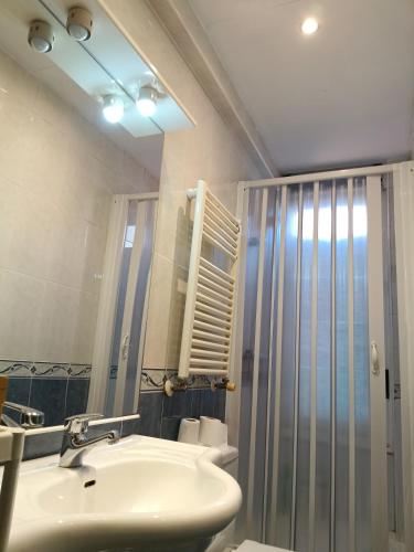 a bathroom with a sink and a shower at Bilbao Room 001 in Bilbao
