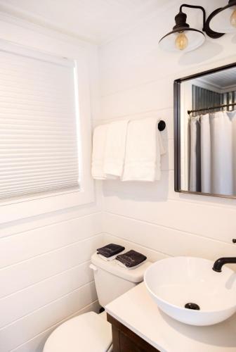 a bathroom with a white toilet and a sink at NEW! Cozy Container Home at Cliffside #2 in Orderville