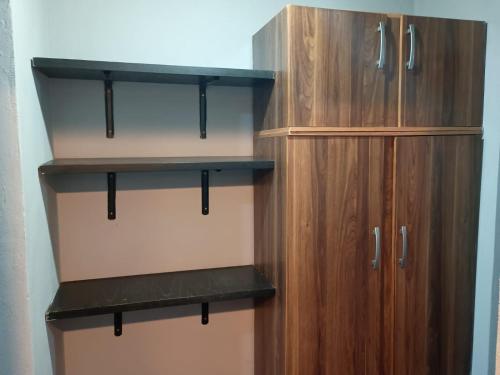 a closet with wooden shelves and wooden cabinets at Los Nonos in Perdriel