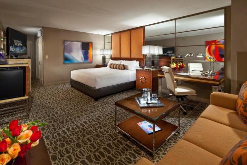a hotel room with a bed and a desk at MGM Grand in Las Vegas