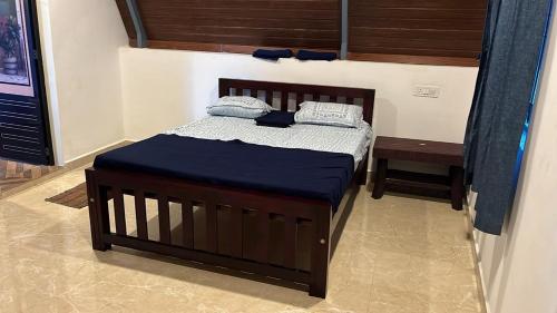 a bedroom with a bed with a blue comforter at Aastha Gokarna in Gokarn