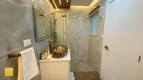 a bathroom with a sink and a shower at 2JA Management Group - Condos White Hill in Sosúa