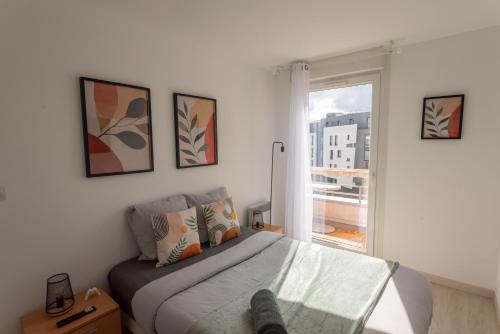 a bedroom with a bed and a window at Warm cocoon - parking included in Asnières-sur-Seine