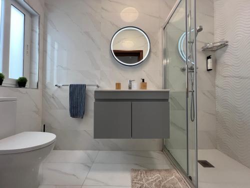 a bathroom with a sink and a shower at Pergola Penthouse Xaghra in Xagħra