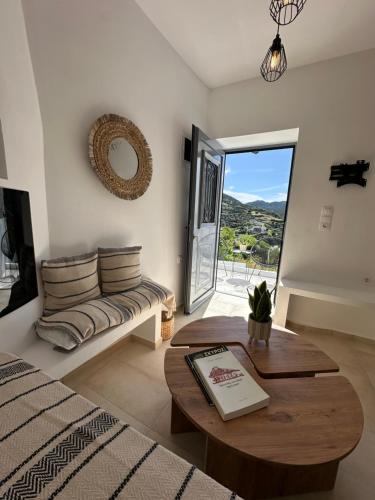 a living room with a couch and a table at Babatseratsi 3 Apartment in Skiros