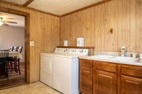 a kitchen with a washing machine and a sink at Beach Boats Beds in Sneads Ferry