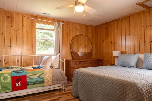 a bedroom with two beds and a mirror at Beach Boats Beds in Sneads Ferry