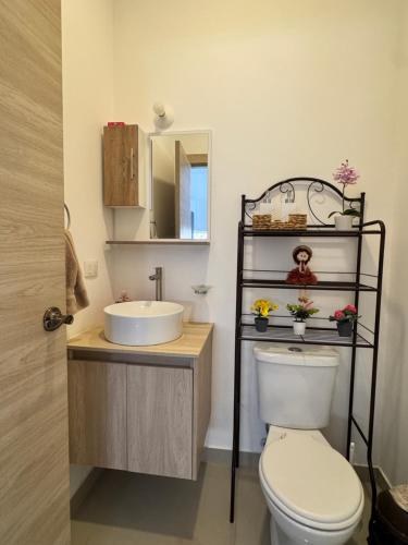 a bathroom with a white toilet and a sink at Casa Privada con Piscina in Salinas