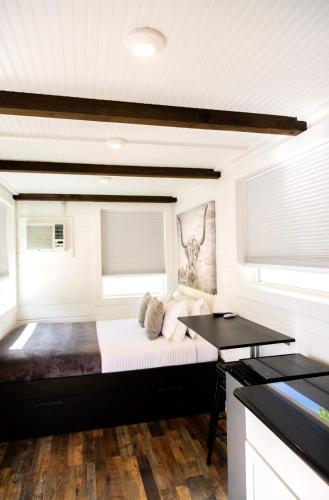 a bedroom with a bed and a desk at NEW! Cozy Container Home at Cliffside #4 in Orderville