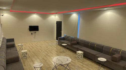 a waiting room with couches and a flat screen tv at استراحة لايك لاين ديراب in Ar Riyāḑ