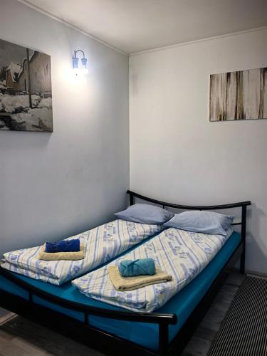 two beds in a room with towels on them at Skadarska in Pančevo