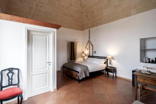 a bedroom with a bed and a table and a chair at Dimora Santa Barbara in Matera