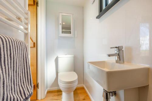 a bathroom with a white toilet and a sink at 1 Bed in Ponsonby oc-l37879 in Gosforth