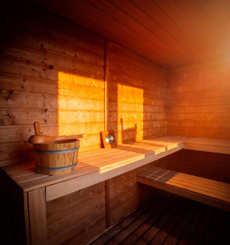 an empty wooden sauna with a bucket in it at Hotel Mezio National Park in Soajo