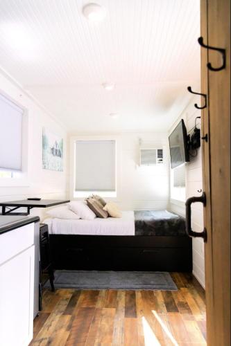 a bedroom with a bed and a television in it at NEW! Cozy Container Home at Cliffside #5 in Orderville