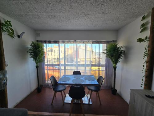 a dining room with a table and chairs and a window at Apparte 104 avec Jacuzzi in Cap d'Agde