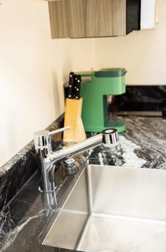 a kitchen counter with a sink and a faucet at NEW! Modern Cabin Tiny Home at Cliffside #1 in Orderville