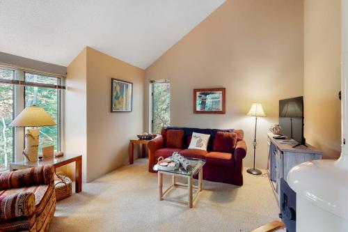 a living room with a couch and a table at Hawks Nest 27 in Glen Arbor