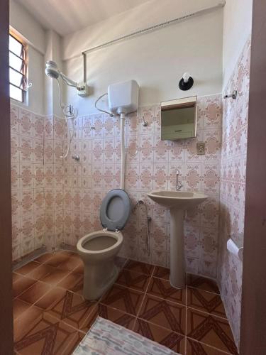 a bathroom with a toilet and a sink at Hotel Ideal in Boa Vista
