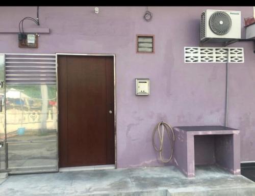 a purple building with a door and a purple wall at LCS Homestay in Pangkor