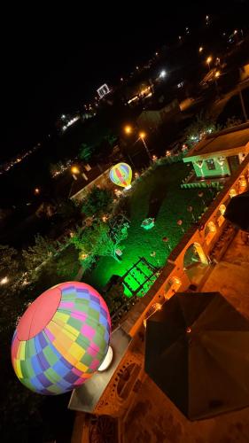 an aerial view of a hot air balloon at night at Cappanar Cave in Nar