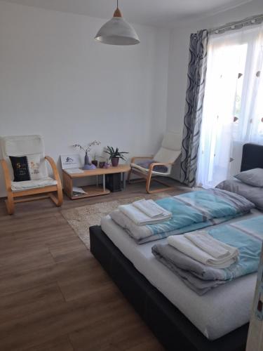 a bedroom with a bed with towels on it at Centralhome in Miskolc