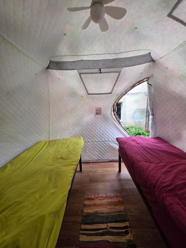 a room with two beds in a tent at Friends glamping & Sauna in Kutaisi