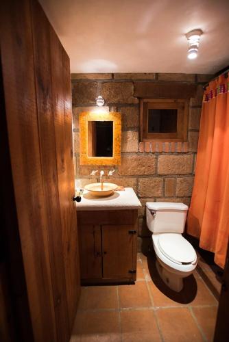 a bathroom with a toilet and a sink at Private Stunning Cottage In Forest Cuernavaca CDMX in Huertas de San Pedro