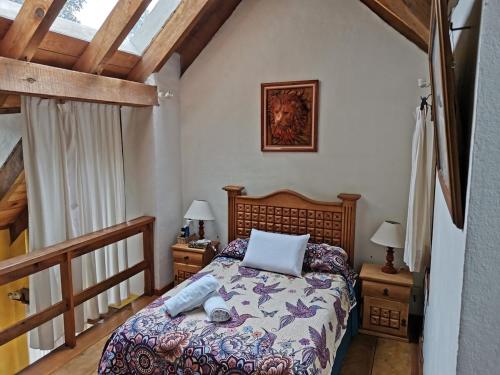 a bedroom with a bed and two night stands with lamps at Private Stunning Cottage In Forest Cuernavaca CDMX in Huertas de San Pedro